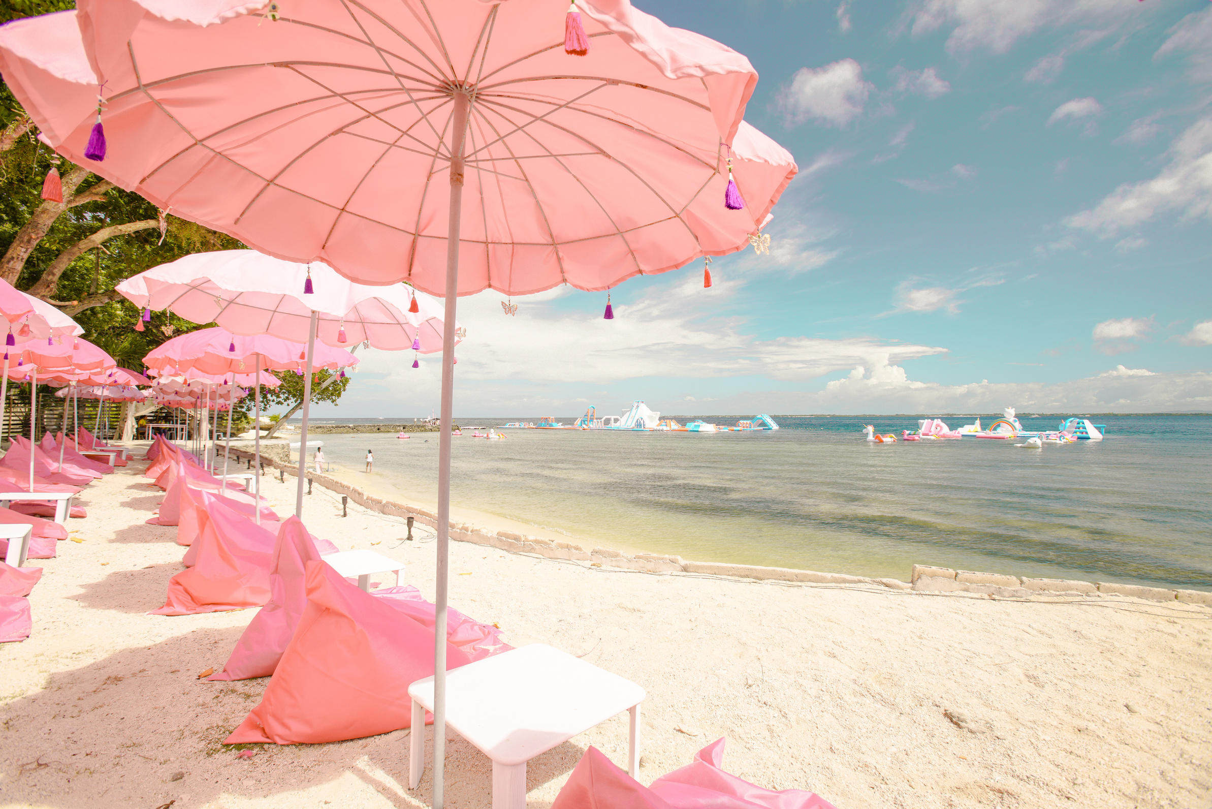 Pink Beach Umbrellas on Sand